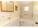 Full bathroom showcasing a tiled shower/tub combo, toilet, and vanity with a mirror at 1405 Paula Dr, Apopka, FL 32703