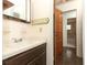 Bathroom featuring a vanity with a mirror and a partial view of the shower-tub combo area at 1405 Paula Dr, Apopka, FL 32703