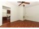 Bedroom with a ceiling fan and light fixture over wood look laminate flooring at 1405 Paula Dr, Apopka, FL 32703