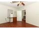 Bedroom with a ceiling fan and light fixture over wood look laminate flooring at 1405 Paula Dr, Apopka, FL 32703