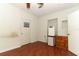 Bedroom with a ceiling fan and light fixture over wood look laminate flooring at 1405 Paula Dr, Apopka, FL 32703