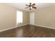 A standard bedroom with wood floors, a ceiling fan, and neutral wall paint at 1405 Paula Dr, Apopka, FL 32703