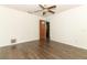 Bright bedroom featuring dark wood flooring, white walls and a ceiling fan at 1405 Paula Dr, Apopka, FL 32703