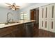 Eat-in kitchen featuring a stainless steel dishwasher, granite countertops and wood cabinets at 1405 Paula Dr, Apopka, FL 32703