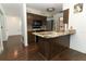 Cozy kitchen featuring granite countertops, stainless steel appliances, and stylish dark wood cabinets at 1405 Paula Dr, Apopka, FL 32703