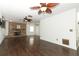 Spacious living room featuring a brick fireplace and dark wood flooring at 1405 Paula Dr, Apopka, FL 32703