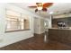 Bright, open living room with wood floors, natural light, and view into the kitchen at 1405 Paula Dr, Apopka, FL 32703