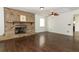 Spacious living room with brick fireplace, wood floors, and a ceiling fan at 1405 Paula Dr, Apopka, FL 32703