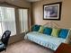 Cozy bedroom with a daybed, bright pillows, and natural light from a large window at 1585 Stefan Cole Ln, Apopka, FL 32703
