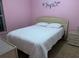 Cozy bedroom with pink walls, double bed, and a bedside table with drawers at 1585 Stefan Cole Ln, Apopka, FL 32703