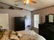 Bedroom featuring a large, dark-wood dresser, neutral carpet, and floral bedding at 1585 Stefan Cole Ln, Apopka, FL 32703