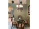 Cozy dining area features a glass-top table, chandelier, and seamless access to the kitchen at 1585 Stefan Cole Ln, Apopka, FL 32703