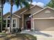 Charming single-story home with a well-manicured lawn and neutral-toned facade at 1585 Stefan Cole Ln, Apopka, FL 32703