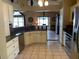Open-concept kitchen featuring a breakfast bar, granite countertops, tile flooring, and stainless steel appliances at 1585 Stefan Cole Ln, Apopka, FL 32703