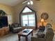 Cozy living room with a vaulted ceiling, ample natural light, a large window, and comfortable furnishings at 1585 Stefan Cole Ln, Apopka, FL 32703