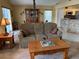 Inviting living room with plush sofa, wooden coffee table, and a view of the dining area at 1585 Stefan Cole Ln, Apopka, FL 32703