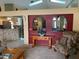 Open-concept living area with a stone kitchen bar, decorative table, and cozy armchair at 1585 Stefan Cole Ln, Apopka, FL 32703
