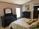 Comfortable main bedroom with a large bed, decorative pillows, and elegant furnishings at 1585 Stefan Cole Ln, Apopka, FL 32703