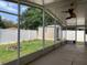 Screened patio with view of fenced backyard with shed and fire pit at 1585 Stefan Cole Ln, Apopka, FL 32703