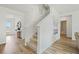 Bright hallway with stairway, leading to a bathroom and other areas of the home at 1890 Walnut Creek Dr, Kissimmee, FL 34744