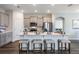 Modern kitchen with stainless steel appliances, a large island, and seating for four at 1974 Walnut Creek Dr, Kissimmee, FL 34744