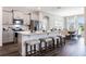 Modern kitchen with stainless steel appliances, a large island, and seating for four at 1974 Walnut Creek Dr, Kissimmee, FL 34744