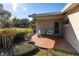 Cozy back patio with brick flooring, outdoor seating, and access to the home's entrance at 2001 Lily Ct, Sanford, FL 32771