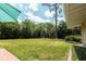 Lush, green backyard offering ample space for recreation and relaxation with tall trees at 2001 Lily Ct, Sanford, FL 32771