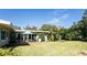 Expansive backyard featuring a patio, lush greenery, and room for outdoor activities at 2001 Lily Ct, Sanford, FL 32771