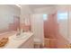 Charming pink tiled bathroom with a vanity sink, toilet, and shower-tub combination at 2001 Lily Ct, Sanford, FL 32771