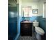Vintage blue bathroom featuring blue tile walls, a dark vanity, and a glass shower at 2001 Lily Ct, Sanford, FL 32771