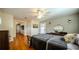 Spacious bedroom featuring hardwood floors, ceiling fan, natural light, and a glimpse into adjacent rooms at 2001 Lily Ct, Sanford, FL 32771