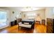 Cozy bedroom featuring hardwood floors, a ceiling fan, and ample natural light from the windows at 2001 Lily Ct, Sanford, FL 32771