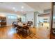 Open-concept dining room with wood floors, fireplace, and a view into the living room at 2001 Lily Ct, Sanford, FL 32771