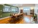 Dining area with hardwood floors, view into kitchen, and plenty of natural light at 2001 Lily Ct, Sanford, FL 32771