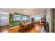 Hardwood-floored dining area with an open layout, leading to a modern kitchen with stainless steel appliances at 2001 Lily Ct, Sanford, FL 32771