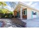 Inviting front porch with brick accents and decorative support beams, nestled in a landscaped yard at 2001 Lily Ct, Sanford, FL 32771