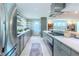 Bright kitchen with stainless steel appliances, ample counter space, and open shelving at 2001 Lily Ct, Sanford, FL 32771