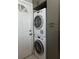 Convenient laundry area with stacked washer and dryer, located near the back door at 2001 Lily Ct, Sanford, FL 32771