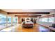 Spacious living room with hardwood floors, exposed beam ceilings, and large windows at 2001 Lily Ct, Sanford, FL 32771