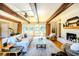 Bright living room featuring wood-beamed ceilings, brick fireplace, and sliding glass doors to the outdoor space at 2001 Lily Ct, Sanford, FL 32771