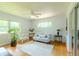 Inviting living room with light blue walls, hardwood floors, bright windows, and a cozy seating arrangement at 2001 Lily Ct, Sanford, FL 32771