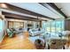 Spacious living room with hardwood floors, beamed ceilings, and sliding glass doors at 2001 Lily Ct, Sanford, FL 32771