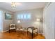 Inviting living room features hardwood floors, two armchairs, and a window with shutters at 2001 Lily Ct, Sanford, FL 32771