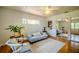 Inviting living room featuring hardwood floors, neutral furniture, and a mirrored closet for added style at 2001 Lily Ct, Sanford, FL 32771