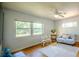Bright living room with hardwood floors, neutral furniture, and large windows providing ample natural light at 2001 Lily Ct, Sanford, FL 32771