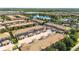 Community aerial view showcasing multiple buildings and residences, a pool, a lake, trees, and the overall neighborhood layout at 2030 Majorca Dr, Kissimmee, FL 34747