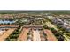 Community aerial view showcasing multiple buildings and residences, a pool, a lake, trees, and the overall neighborhood layout at 2030 Majorca Dr, Kissimmee, FL 34747