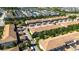 Aerial view of a residential neighborhood with townhouses, single-Gathering homes, and a pond at 2030 Majorca Dr, Kissimmee, FL 34747