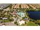 Community aerial view showcasing multiple buildings and residences, a pool, a lake, trees, and the overall neighborhood layout at 2030 Majorca Dr, Kissimmee, FL 34747